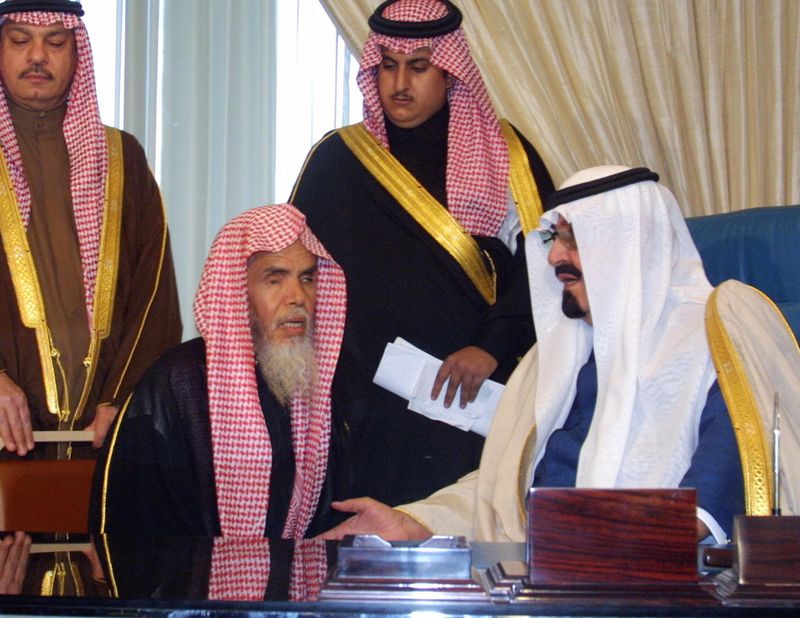 The late King Abdullah meets with an unidentified member of the religious police